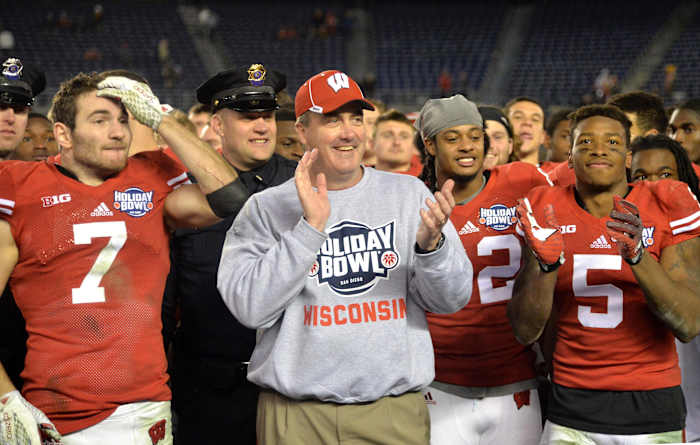 Paul Chryst smiling with players after winning the Holiday Bowl.